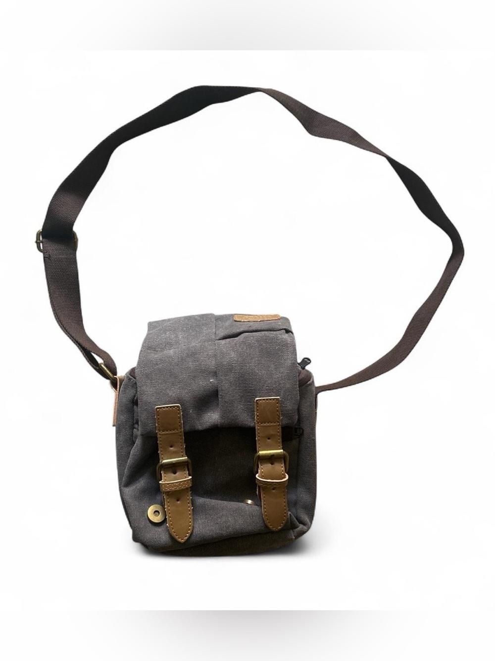 Gray canvas crossbody camera bag with brown leather straps and buckles